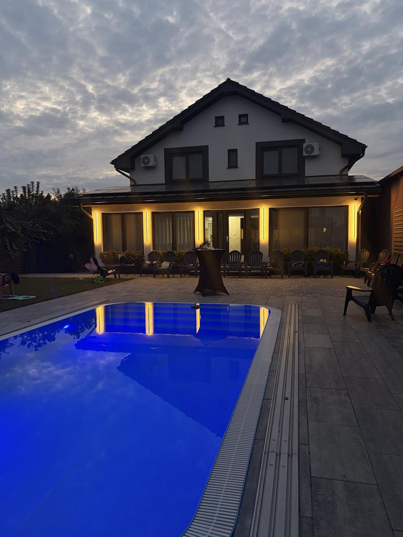 Piscina deschisă la lăsarea serii, cu lumina albastră